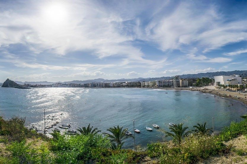 Wide panoramic shot of Águilas Bay in Murcia with calm waters, boats, and the Mediterranean skyline