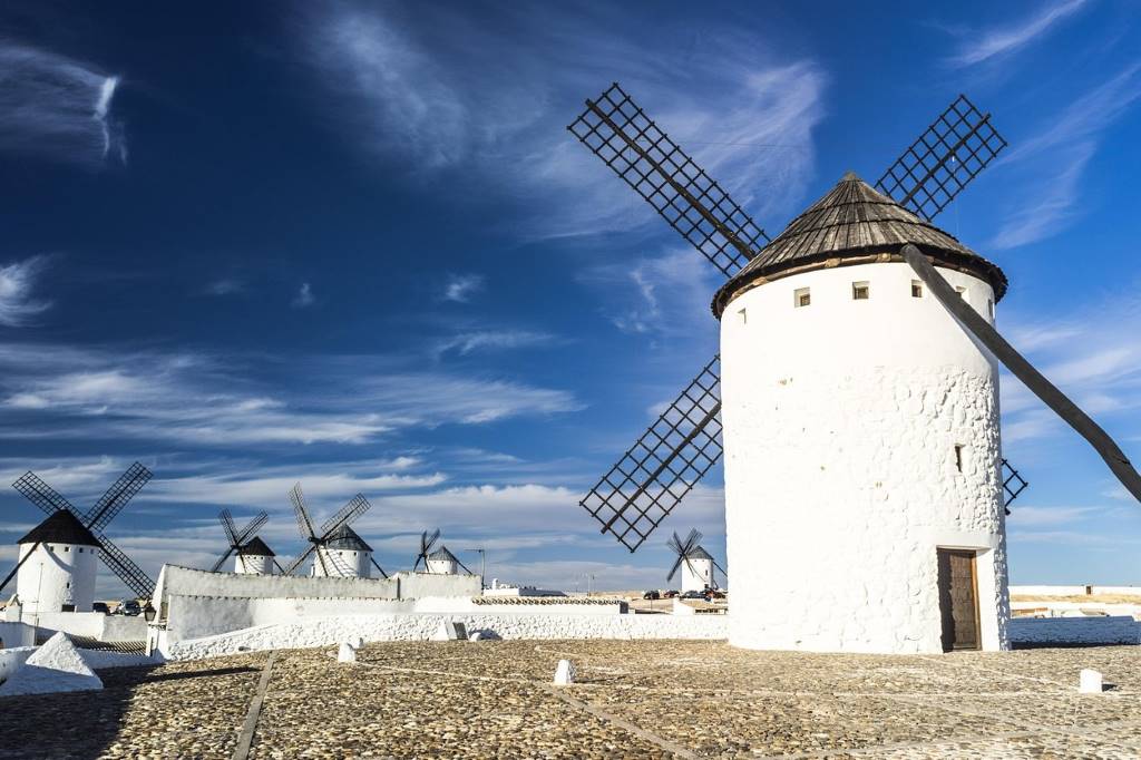 Traditional white windmills of Consuegra under blue sky in Castilla-La Mancha, Spain